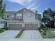Charming two-story townhome featuring two-car garage, neutral paint, and beautiful architectural details at 8419 Chamberlain Pl, Oviedo, FL 32765