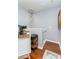 Hallway features hardwood floors, white trim, chandelier lighting, and mini fridge station at 8419 Chamberlain Pl, Oviedo, FL 32765