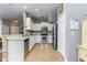 Modern kitchen features white cabinets, stainless steel appliances, and stone accent wall at 8419 Chamberlain Pl, Oviedo, FL 32765