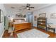 Large main bedroom features hardwood floors, ceiling fan, and stylish decor at 8419 Chamberlain Pl, Oviedo, FL 32765