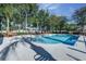 Community pool with chairs for lounging with a fence and trees around the perimeter at 8419 Chamberlain Pl, Oviedo, FL 32765