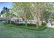 Community pool surrounded by manicured landscaping and mature shade trees at 8419 Chamberlain Pl, Oviedo, FL 32765