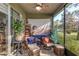 Screened porch furnished with cushioned chairs and decorative items, creating an inviting outdoor space at 8419 Chamberlain Pl, Oviedo, FL 32765