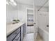 Bathroom vanity and tub/shower combination with white tiling at 8997 Lee Vista Blvd # 2009, Orlando, FL 32829