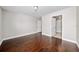 Bedroom with hardwood floors and doors leading to other rooms at 8997 Lee Vista Blvd # 2009, Orlando, FL 32829