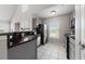 Well-lit kitchen with stainless steel appliances and white tile flooring at 8997 Lee Vista Blvd # 2009, Orlando, FL 32829