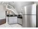 Kitchen featuring stainless steel refrigerator, granite counters, and stairs leading to upper level at 8997 Lee Vista Blvd # 2009, Orlando, FL 32829