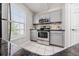 Bright kitchen with stainless steel appliances and grey cabinets at 8997 Lee Vista Blvd # 2009, Orlando, FL 32829