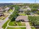 Aerial view of a home nestled within a mature residential community at 901 Cornell Ave, Clermont, FL 34711