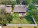 Expansive aerial view of the property showcasing a large backyard with a patio and well-maintained landscaping at 901 Cornell Ave, Clermont, FL 34711