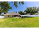 Large backyard with patio furniture, grill, and green lawn at 901 Cornell Ave, Clermont, FL 34711