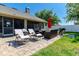 Inviting backyard featuring a paved patio with outdoor furniture, a grill, and a well-maintained lawn at 901 Cornell Ave, Clermont, FL 34711