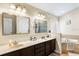 Bathroom featuring double sinks, a soaking tub, and modern fixtures at 901 Cornell Ave, Clermont, FL 34711