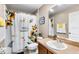 Bright bathroom with sunflower shower curtain, vanity, and framed art at 901 Cornell Ave, Clermont, FL 34711
