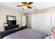 Bedroom featuring a large closet, ceiling fan, and a view into the hallway at 901 Cornell Ave, Clermont, FL 34711