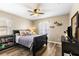 Cozy bedroom featuring hardwood floors, ceiling fan, and decorative shelving at 901 Cornell Ave, Clermont, FL 34711