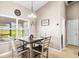 Bright dining area features a square table set, lovely decor, and natural light streaming through the window at 901 Cornell Ave, Clermont, FL 34711
