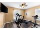 Workout room with stationary bike, rowing machine, hardwood floors, and large windows at 901 Cornell Ave, Clermont, FL 34711