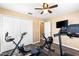 Workout room featuring a treadmill, stationary bike, wall mounted TV, and closet at 901 Cornell Ave, Clermont, FL 34711