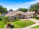Inviting home with lush green lawn, mature trees, and a welcoming front entrance at 901 Cornell Ave, Clermont, FL 34711