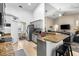 Open kitchen with granite countertops, grey cabinetry, and stainless steel appliances at 901 Cornell Ave, Clermont, FL 34711