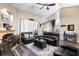Inviting living room with a cozy fireplace, wood flooring, and ample seating for Gathering and friends at 901 Cornell Ave, Clermont, FL 34711