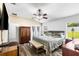 Comfortable main bedroom with wood floors, a ceiling fan, and large windows offering great sunlight at 901 Cornell Ave, Clermont, FL 34711