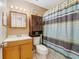 Cozy bathroom showcasing a vanity, storage cabinet, and a shower with a stylish curtain at 9231 Ventana Ln, Orlando, FL 32825