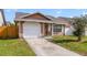 Charming single-Gathering home featuring a one-car garage, and a well-maintained lawn at 9231 Ventana Ln, Orlando, FL 32825