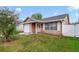 Charming single-story home with a well-maintained lawn and a cozy front porch at 9231 Ventana Ln, Orlando, FL 32825