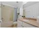 Bright bathroom featuring a shower over the tub, neutral color scheme, and modern vanity at 9478 Silver Buttonwood St, Orlando, FL 32832