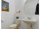 Powder room featuring a pedestal sink, tropical wall art, and neutral decor at 9478 Silver Buttonwood St, Orlando, FL 32832