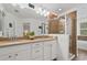 Bathroom with a double sink vanity and tiled walk-in shower with glass door at 9478 Silver Buttonwood St, Orlando, FL 32832