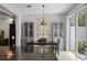 Dining area adjacent to the kitchen, with a view of the backyard and built-in cabinets at 9478 Silver Buttonwood St, Orlando, FL 32832