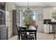 Dining area features a dark table, stylish light fixture, and sliding glass doors to the backyard at 9478 Silver Buttonwood St, Orlando, FL 32832
