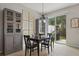 Dining area boasts a dark wood table, backyard access, and built in storage at 9478 Silver Buttonwood St, Orlando, FL 32832