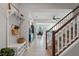 Bright foyer featuring tile flooring, coat rack, and staircase to the second floor at 9478 Silver Buttonwood St, Orlando, FL 32832
