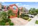 Charming townhomes with colorful exteriors, lush landscaping, and brick-paved driveways at 9478 Silver Buttonwood St, Orlando, FL 32832