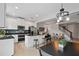Bright and open kitchen with an island, stainless steel appliances, and an adjacent living area at 9478 Silver Buttonwood St, Orlando, FL 32832