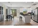 Bright kitchen with white cabinets, stainless steel appliances, and an island with bar seating at 9478 Silver Buttonwood St, Orlando, FL 32832