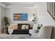 Comfortable living room featuring neutral walls, area rug, and large coastal painting at 9478 Silver Buttonwood St, Orlando, FL 32832