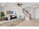 Cozy living room featuring neutral walls, ceiling fan, and staircase to the upper level at 9478 Silver Buttonwood St, Orlando, FL 32832