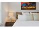Close up on main bedroom with decorative pillows, side tables, and bedside lamps at 9478 Silver Buttonwood St, Orlando, FL 32832