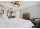Main bedroom featuring a ceiling fan, two dressers, and a decorative chair at 9478 Silver Buttonwood St, Orlando, FL 32832