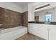 Modern bathroom features sleek white cabinetry, granite countertops, and stylish brown tiled walls at 150 E Robinson St # 2506, Orlando, FL 32801