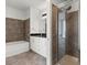 Well-appointed bathroom showcasing tub and shower with floor-to-ceiling brown tile at 150 E Robinson St # 2506, Orlando, FL 32801