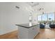 Open concept kitchen flows into the living room featuring large windows and balcony access at 150 E Robinson St # 2506, Orlando, FL 32801