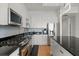 Modern kitchen featuring stainless steel appliances, granite countertops, and white cabinets at 150 E Robinson St # 2506, Orlando, FL 32801