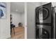 Convenient laundry closet featuring a stacked washer and dryer; adjoins bonus room at 150 E Robinson St # 2506, Orlando, FL 32801