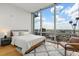 Modern primary bedroom with large windows offering stunning city views at 150 E Robinson St # 2506, Orlando, FL 32801